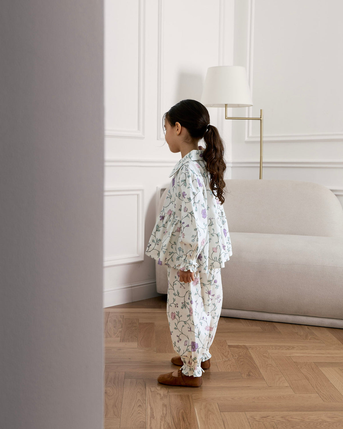 Side view of a girl in the Avaacha Aya Set in Oopsie Daisy Print