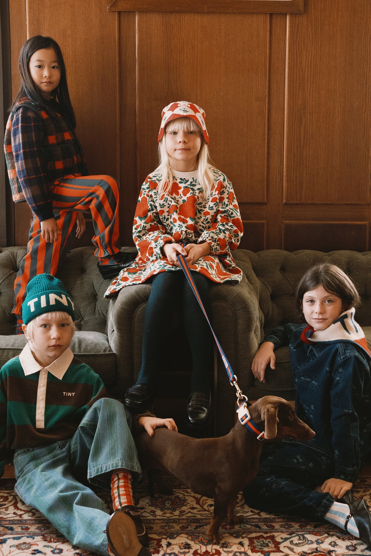 Group of children in Tinycottons prints sitting together indoors