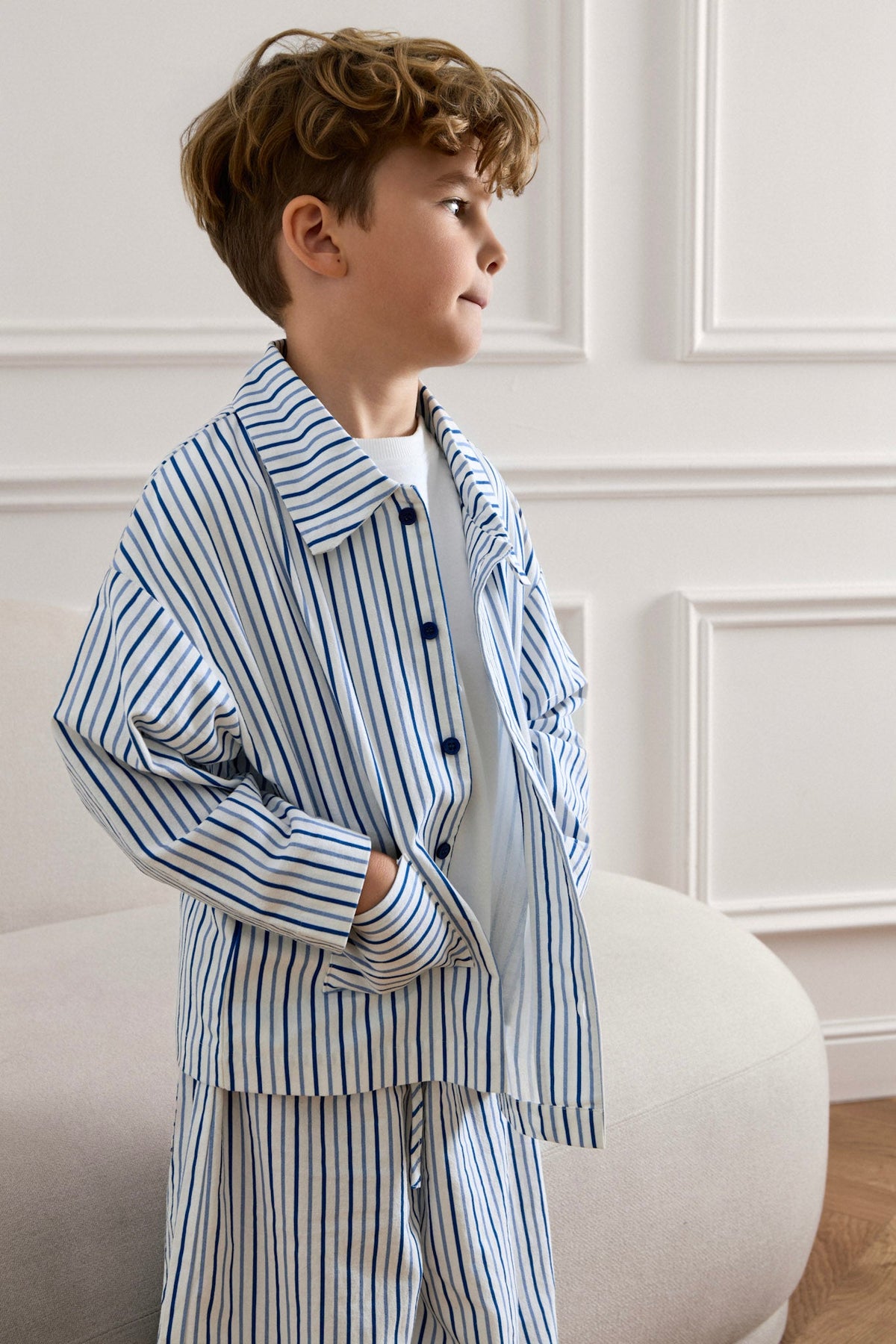 Close-up of a boy wearing the Avaacha Kai striped cotton linen shacket