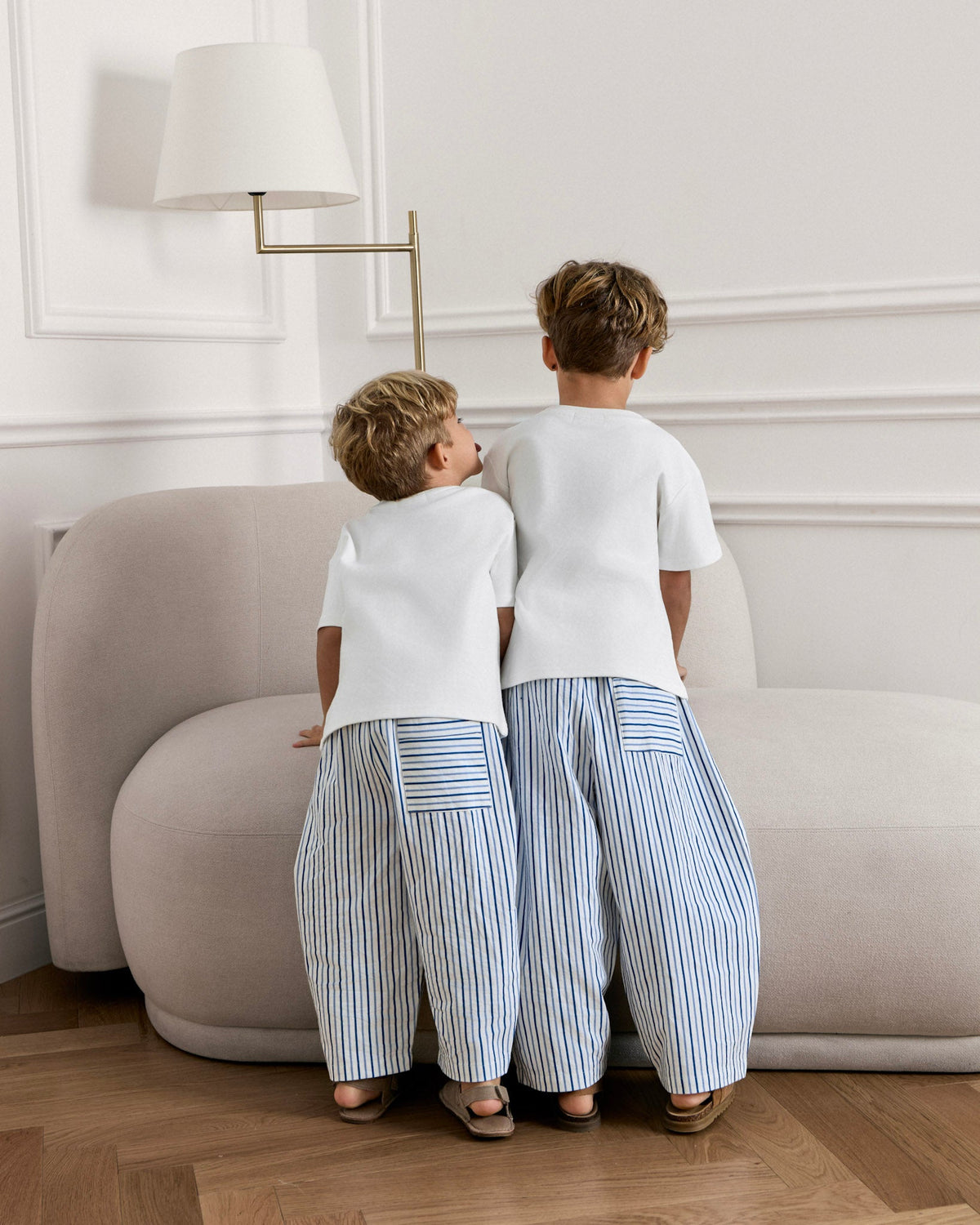 Two boys from behind, one in the Avaacha Kai Set striped pants