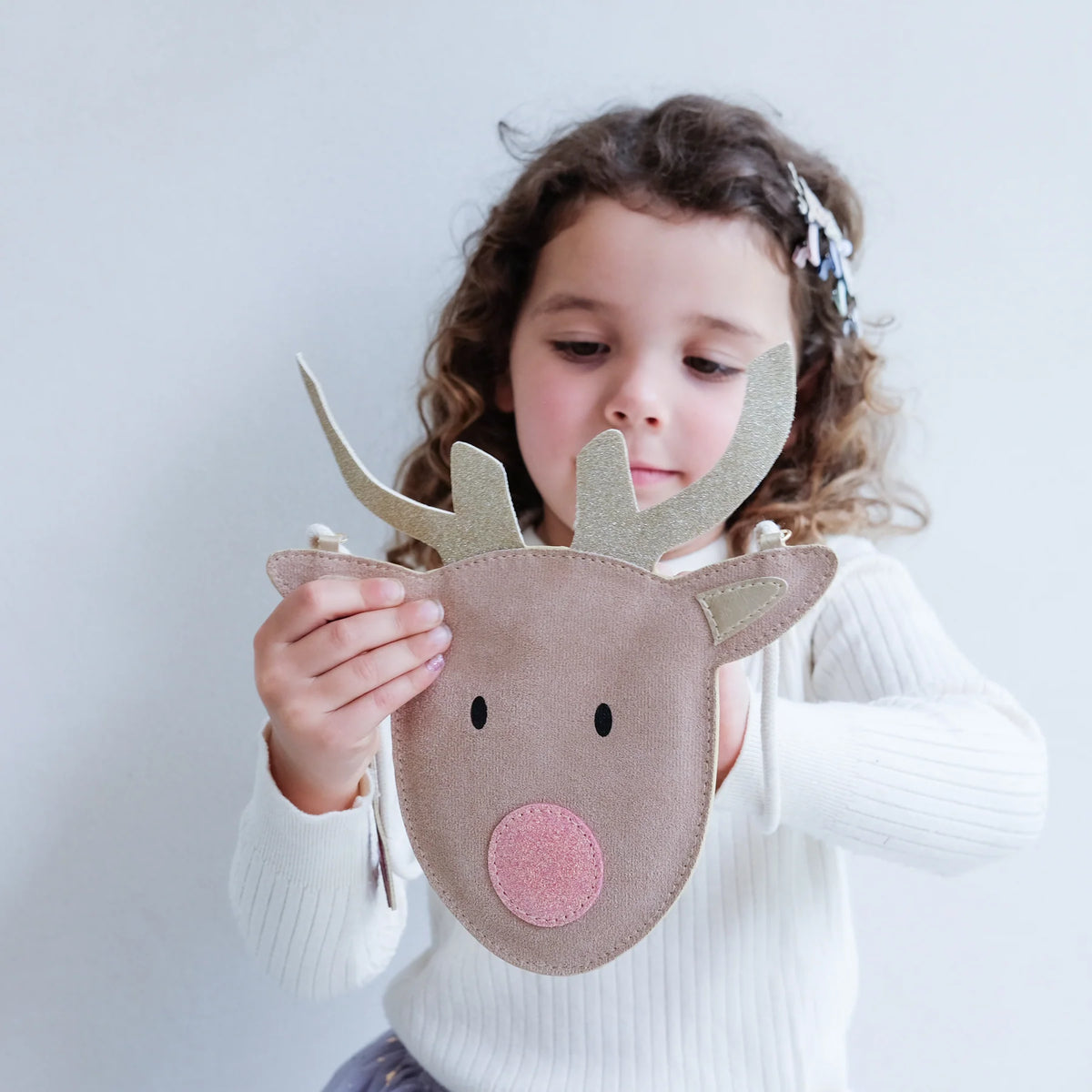 Girl holding the Mimi & Lulu reindeer bag