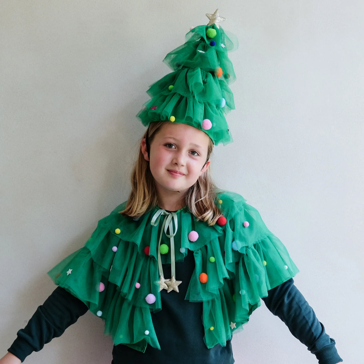 Girl in the green tulle Christmas tree cape and hat, front view
