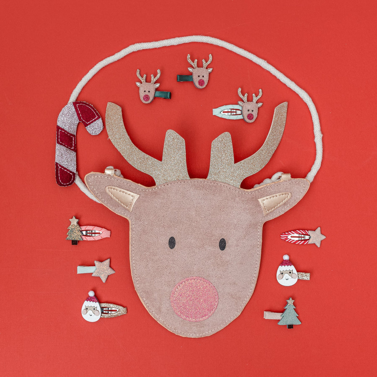 Mimi & Lulu reindeer bag with hair clips on a red background