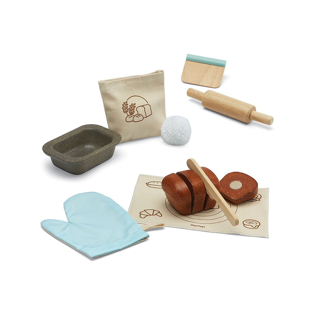 PlanToys bread loaf set laid out with tin, rolling pin and mitt