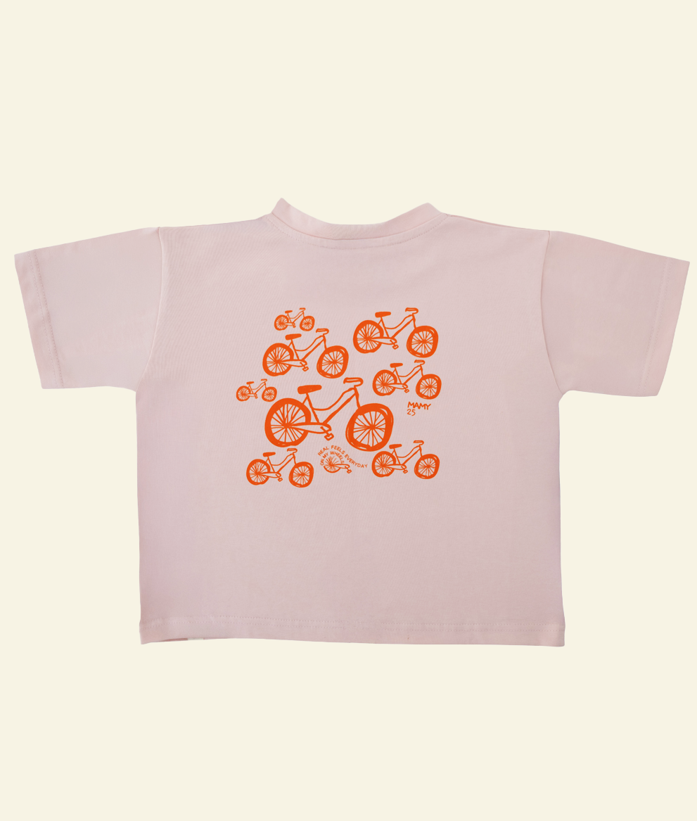 Back of the Oupah Wheels Feels Tee with orange wheels print