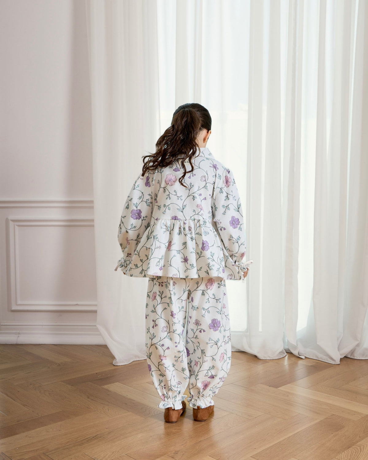 Back view of a girl in the Avaacha Aya floral cotton linen set