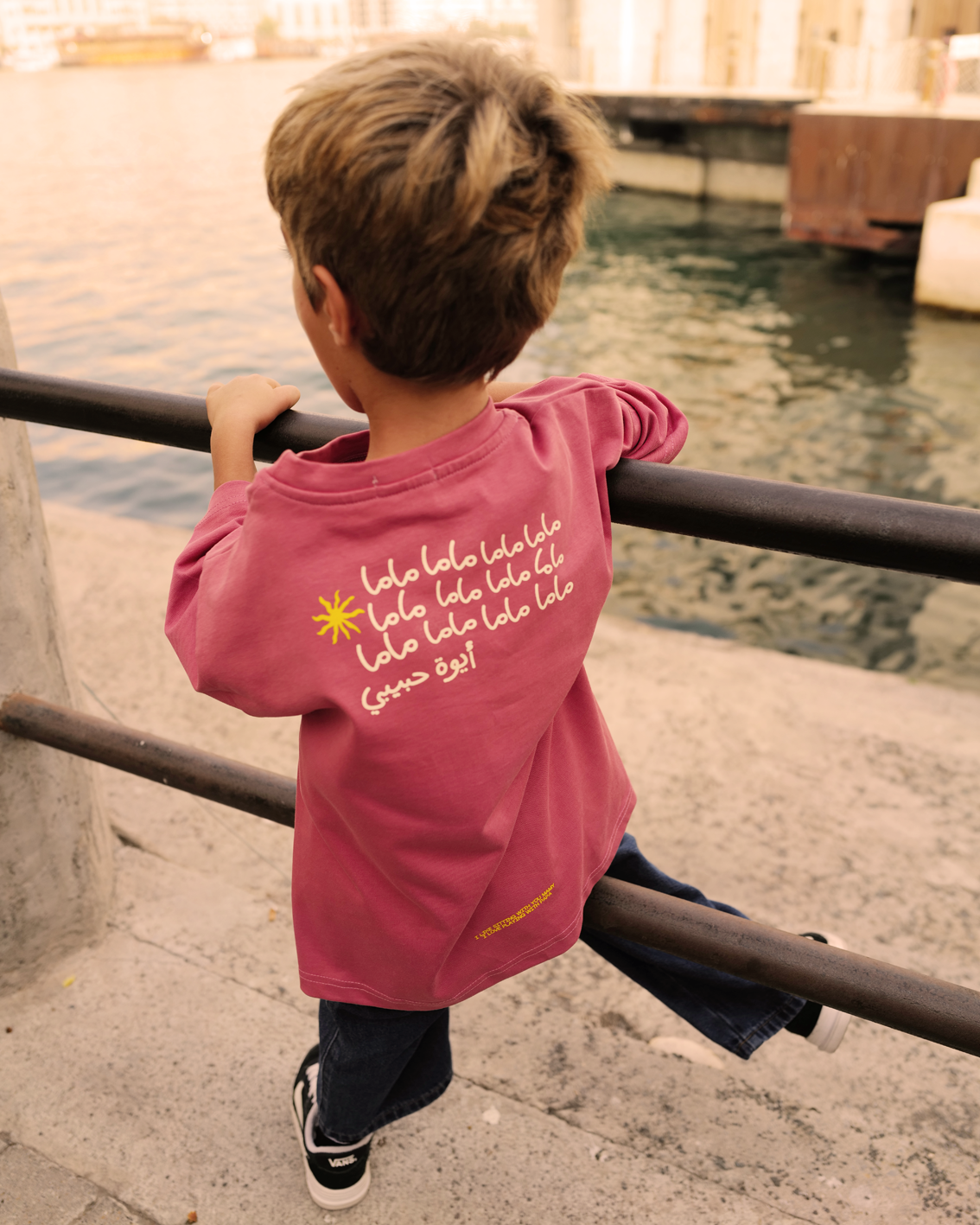 Child wearing the dusty rose Oupah Mama Tee, showing the cream Mama print on the back