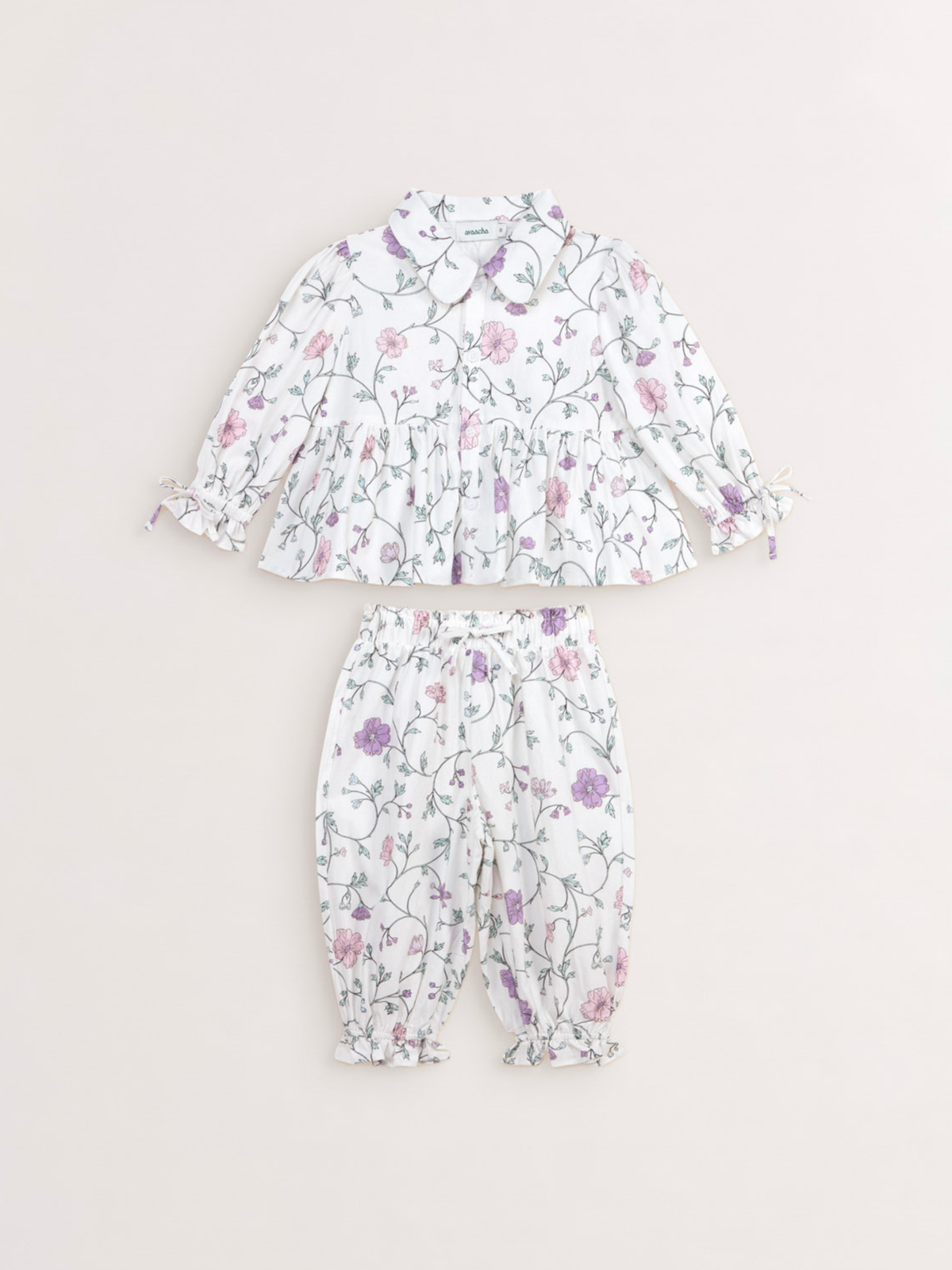 Avaacha Aya Set in Oopsie Daisy Print: white floral top with ruffle collar and gathered-cuff pants