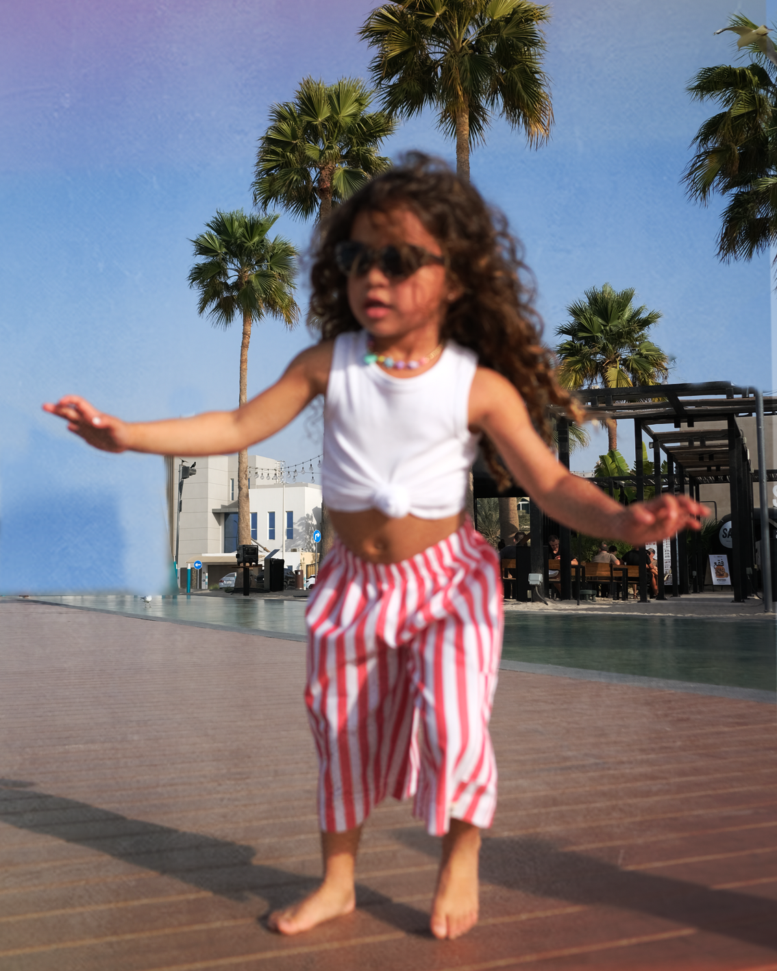 Little girl dancing in the red and white striped Oupah Ringmaster Pants